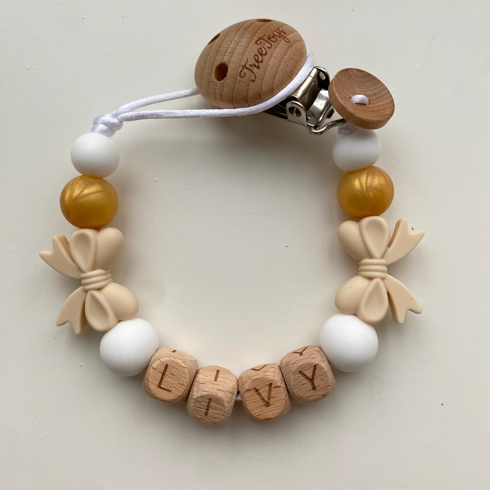 Speenkoord met naam strikjes goud