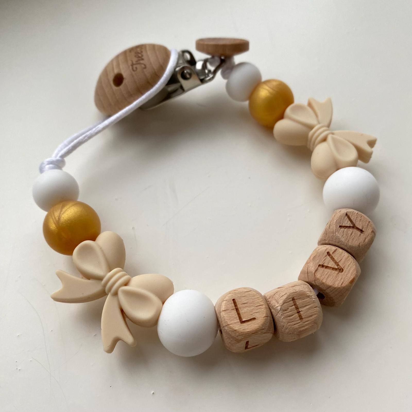 Speenkoord met naam strikjes goud